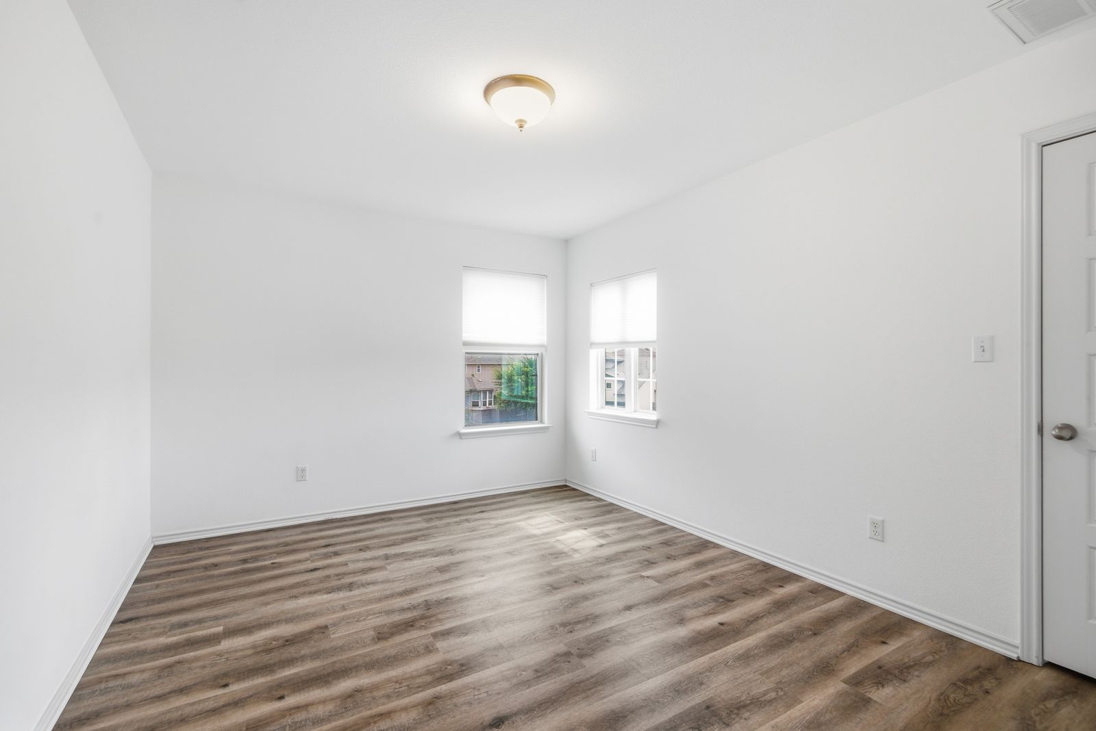 8012 Izetta Lane Austin, TX 78744 - Photo 17 of 27 an empty room with wooden floor and windows