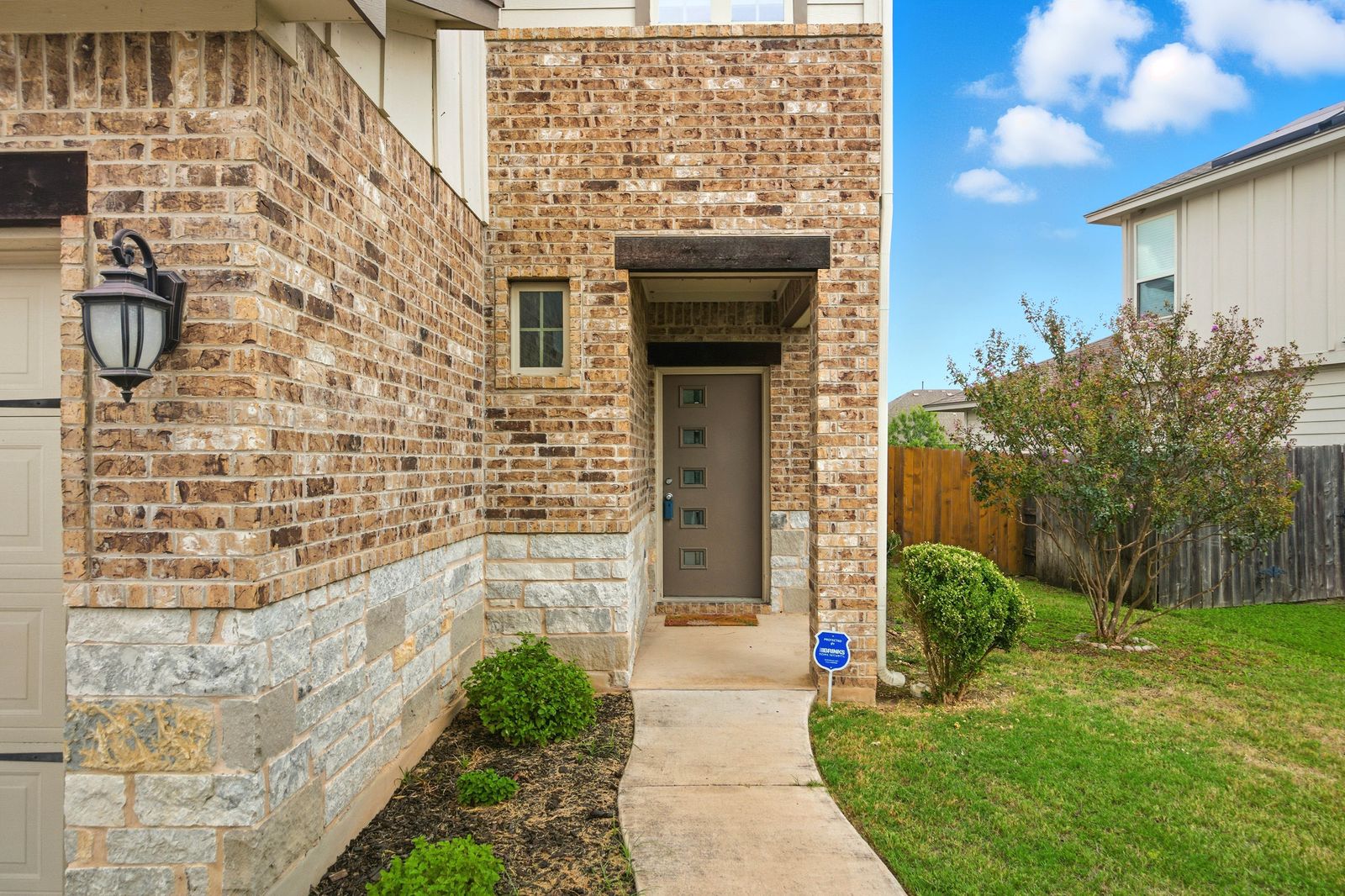 8012 Izetta Lane Austin, TX 78744 - Photo 2 of 27 a front view of a house with a garden