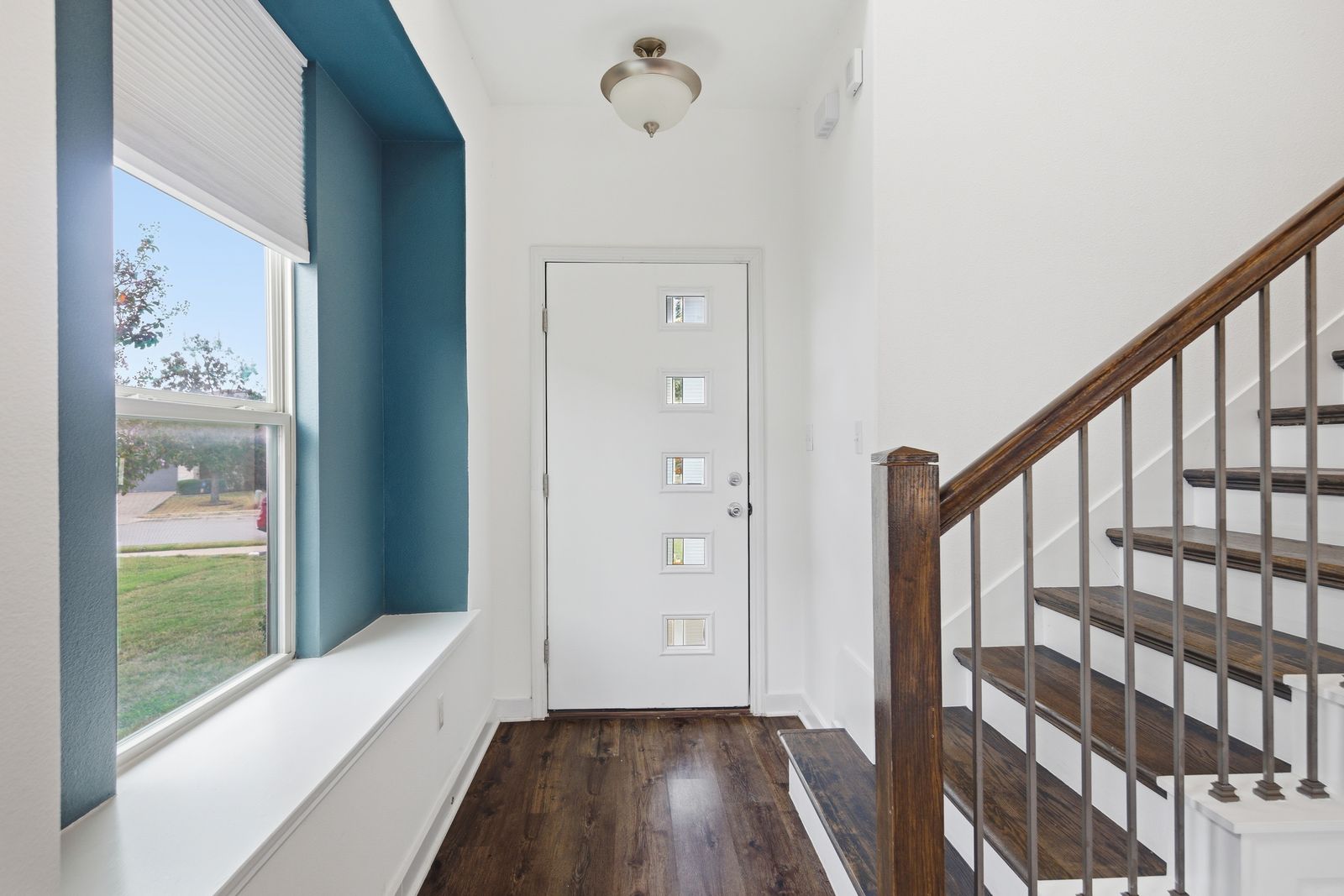 8012 Izetta Lane Austin, TX 78744 - Photo 3 of 27 a view of a hallway with wooden floor and staircase