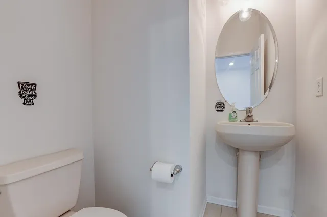 a bathroom with a sink a toilet and a mirror