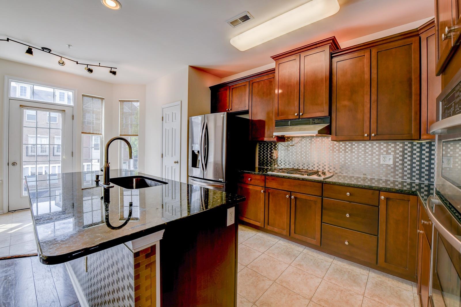 23 Creekside Court, Unit 23 Secaucus, NJ 07094 - Photo 18 of 38 a kitchen with stainless steel appliances granite countertop a sink refrigerator and cabinets