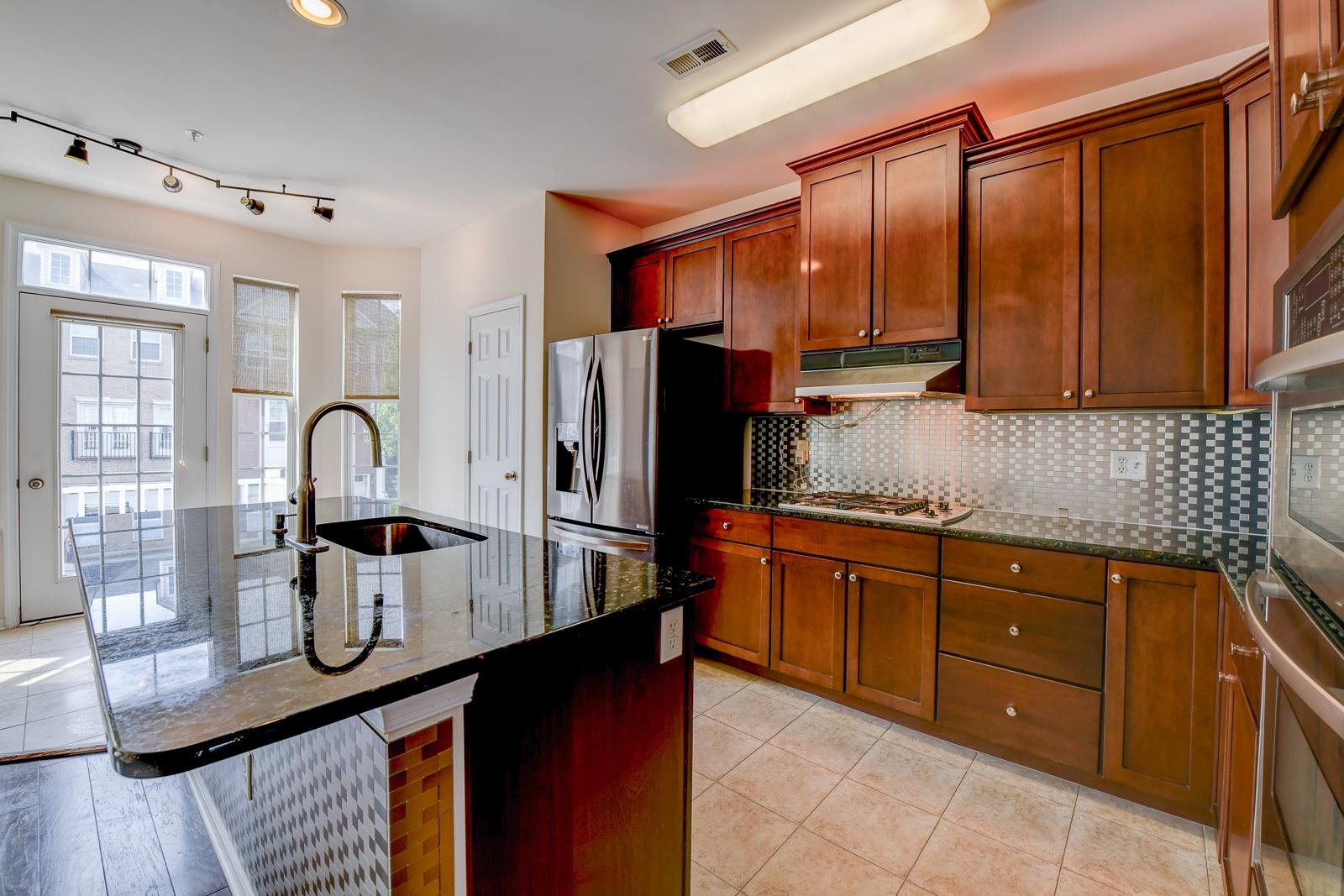 23 Creekside Court, Unit 23 Secaucus, NJ 07094 - Photo 19 of 38 a kitchen with stainless steel appliances granite countertop a sink refrigerator and cabinets