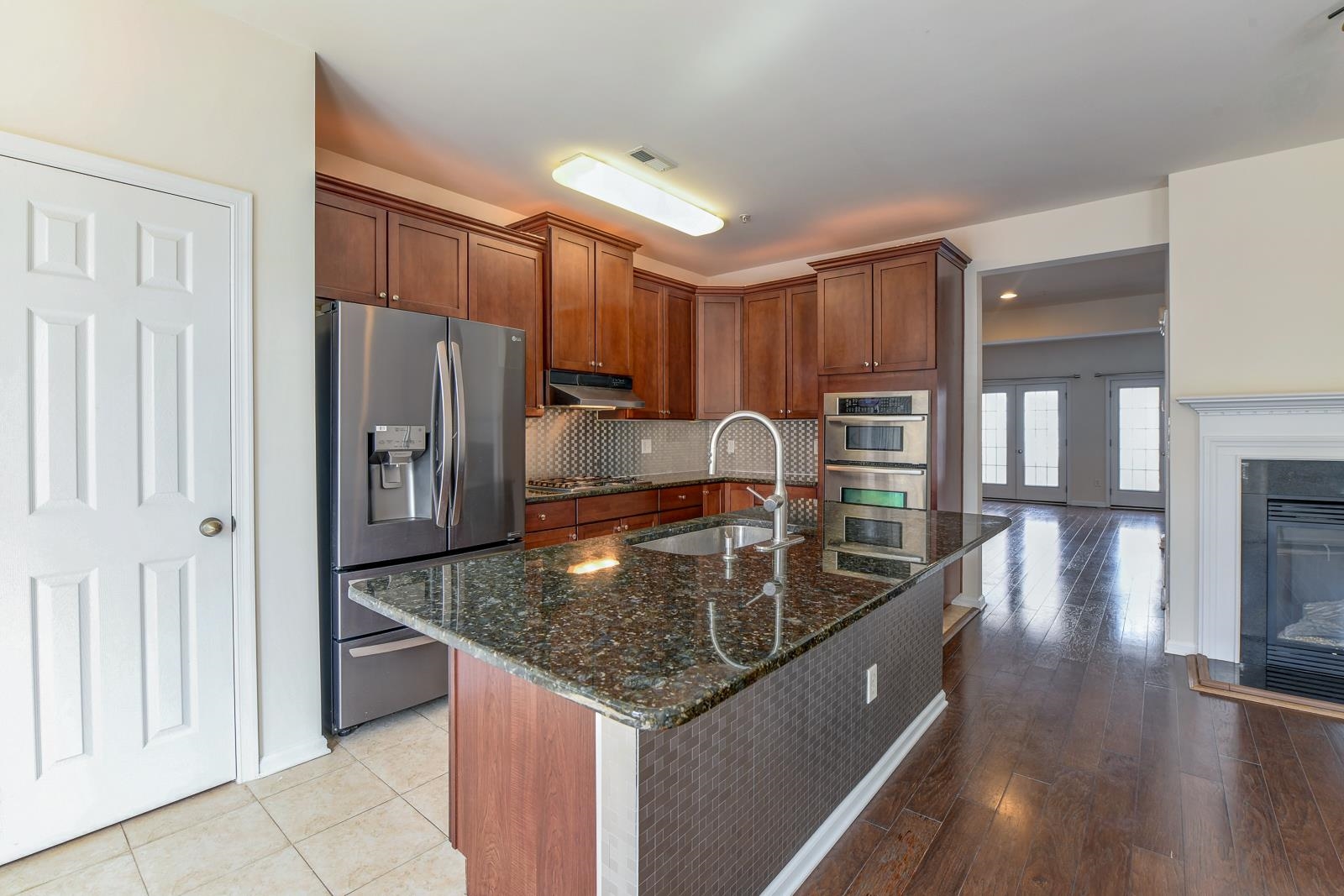 23 Creekside Court, Unit 23 Secaucus, NJ 07094 - Photo 26 of 38 a kitchen with stainless steel appliances granite countertop a sink a refrigerator and a stove