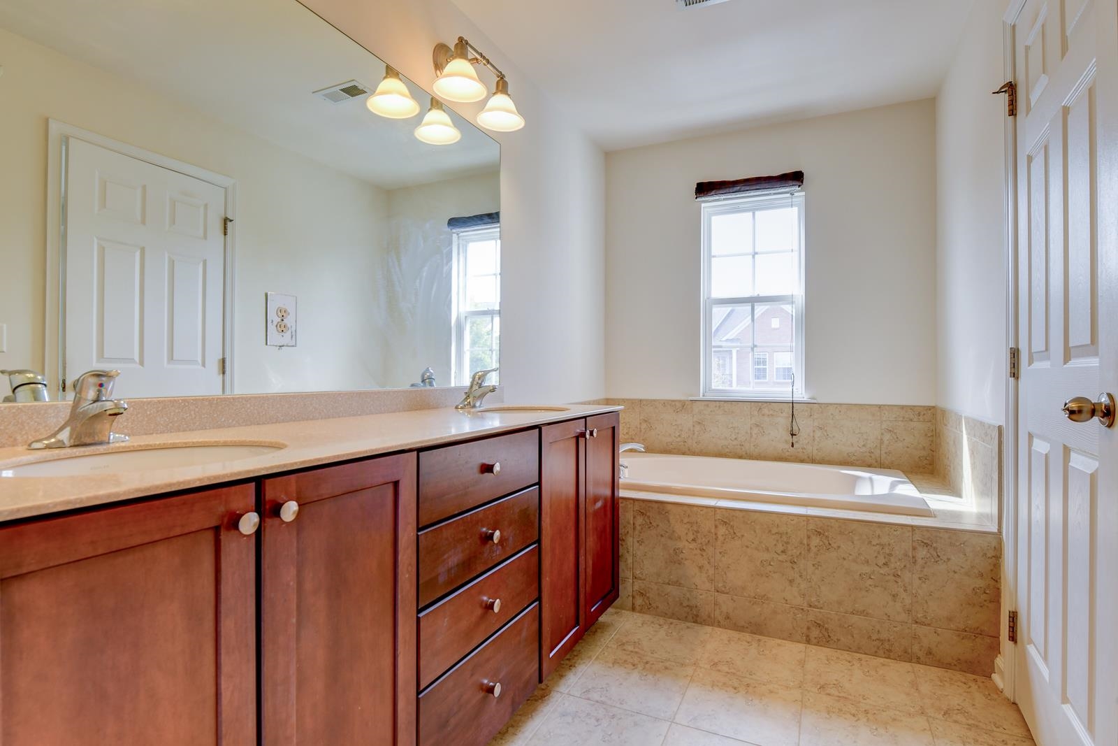 23 Creekside Court, Unit 23 Secaucus, NJ 07094 - Photo 29 of 38 a bathroom with a tub sink and mirror