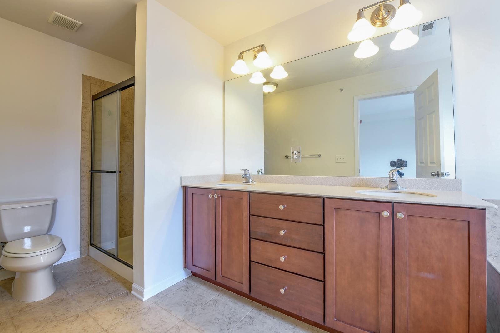 23 Creekside Court, Unit 23 Secaucus, NJ 07094 - Photo 38 of 38 a spacious bathroom with a double vanity sink a toilet and a mirror