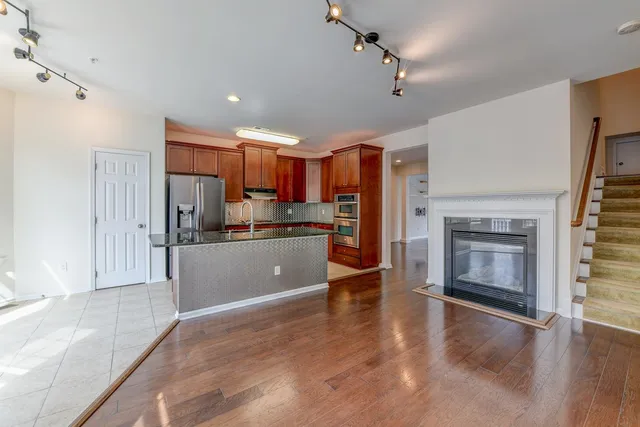 a kitchen with stainless steel appliances a refrigerator sink and microwave