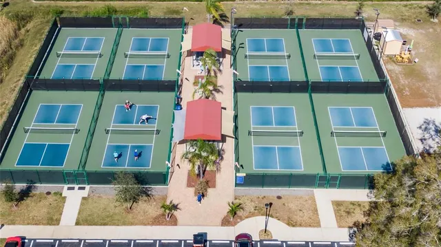 an aerial view of residential houses with outdoor space and lake view