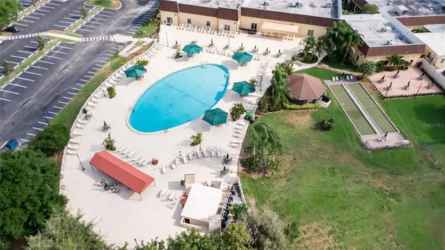 a view of yard with swimming pool and sitting area