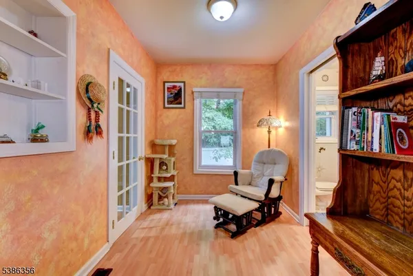 a view of a livingroom with workspace and a window