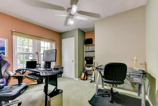 a view of a workspace with furniture and a window