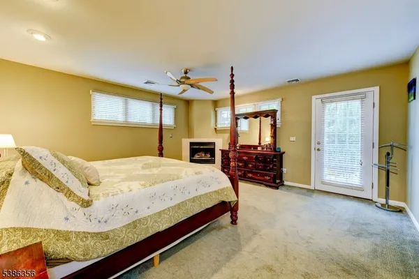 a bed room with a bed mirror and a chair