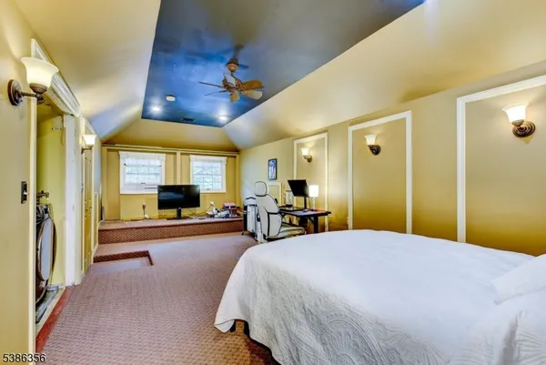 a bedroom with a bed a couch and dresser