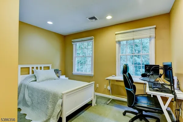 a bed room with a bed and a chair