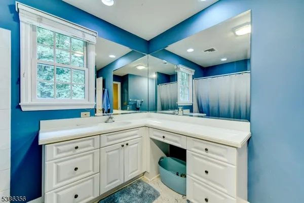 a bathroom with a sink double vanity and a mirror