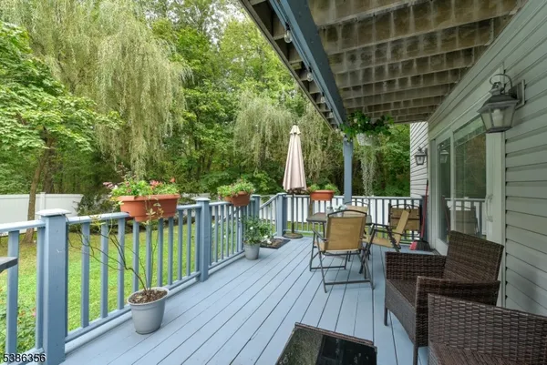a view of a chair and tables in the balcony