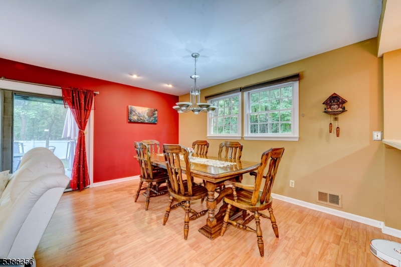 481 Terrill Road Fanwood, NJ 07023 - Photo 7 of 31 a dining room with furniture a chandelier and wooden floor