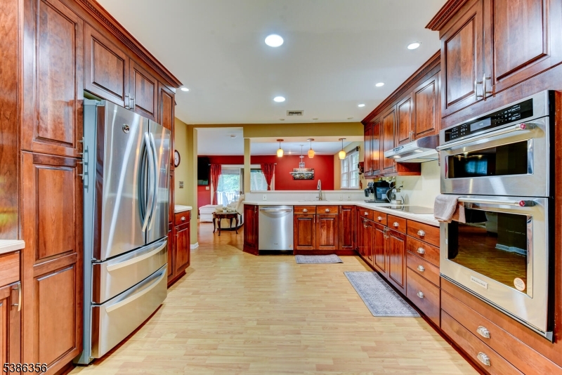 481 Terrill Road Fanwood, NJ 07023 - Photo 8 of 31 a kitchen with stainless steel appliances granite countertop a refrigerator a stove and a wooden floors