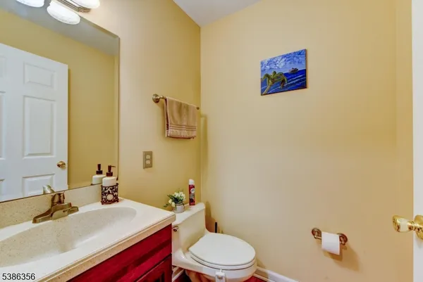 a bathroom with a sink a toilet and mirror