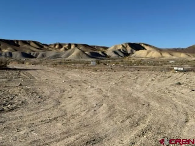 a view of wooden fence and a mountain view in back