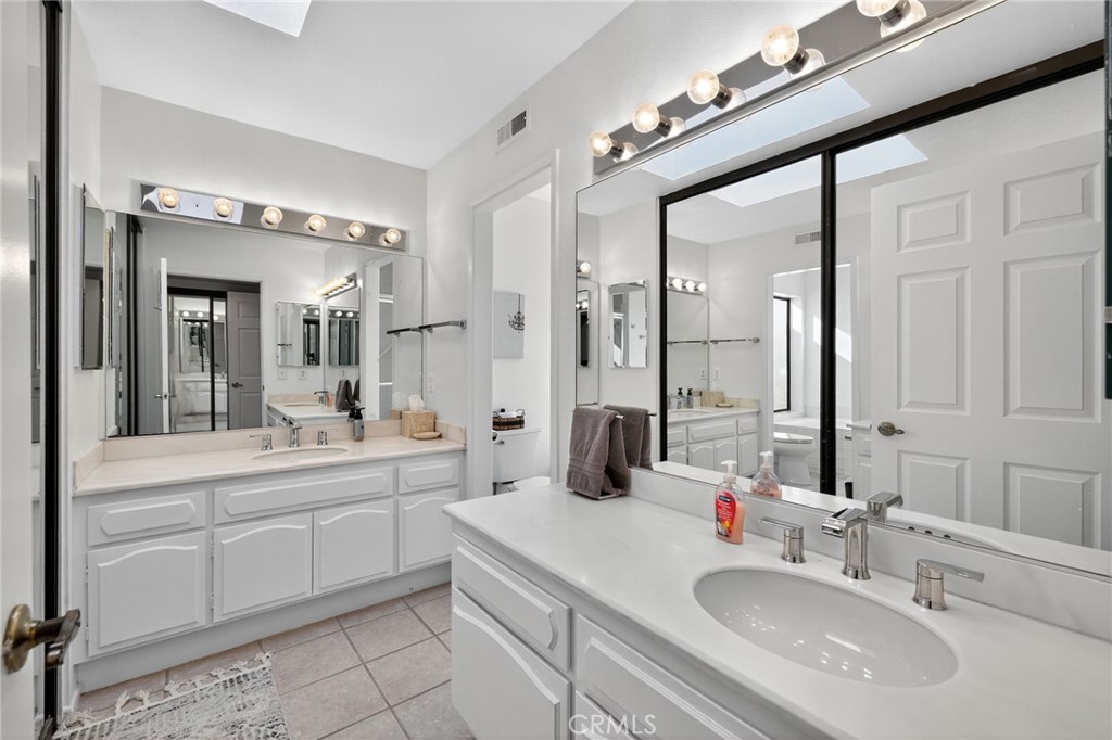 610 Violeta Drive Palm Springs, CA 92262 - Photo 15 of 25 a bathroom with a sink vanity granite tub and a mirror