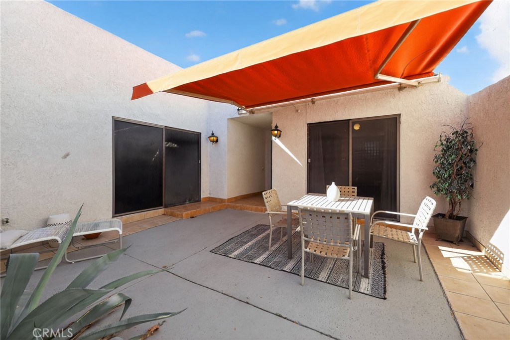 610 Violeta Drive Palm Springs, CA 92262 - Photo 22 of 25 a patio with a table and chairs and potted plants