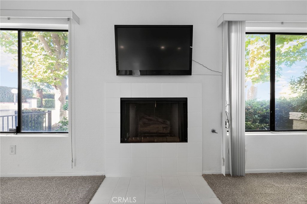 610 Violeta Drive Palm Springs, CA 92262 - Photo 7 of 25 a living room with fireplace and a flat screen tv