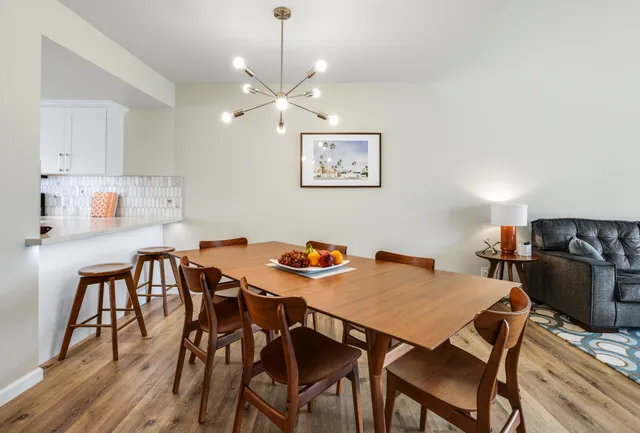 a living room with furniture a flat screen tv and a floor to ceiling window