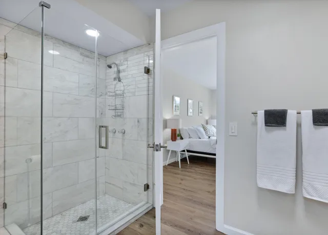 a view of a patio with table and chairs under an umbrella
