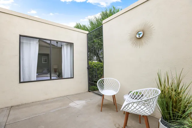 a view of a chair and table in the patio