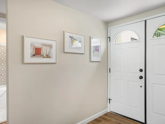 a kitchen with white cabinets and appliances
