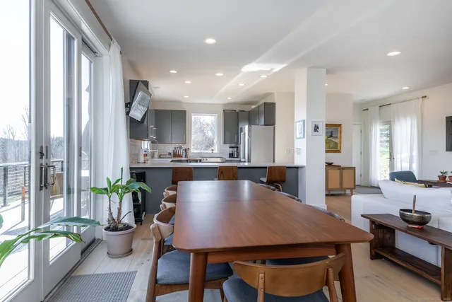 a view of a dining room with furniture and a potted plant