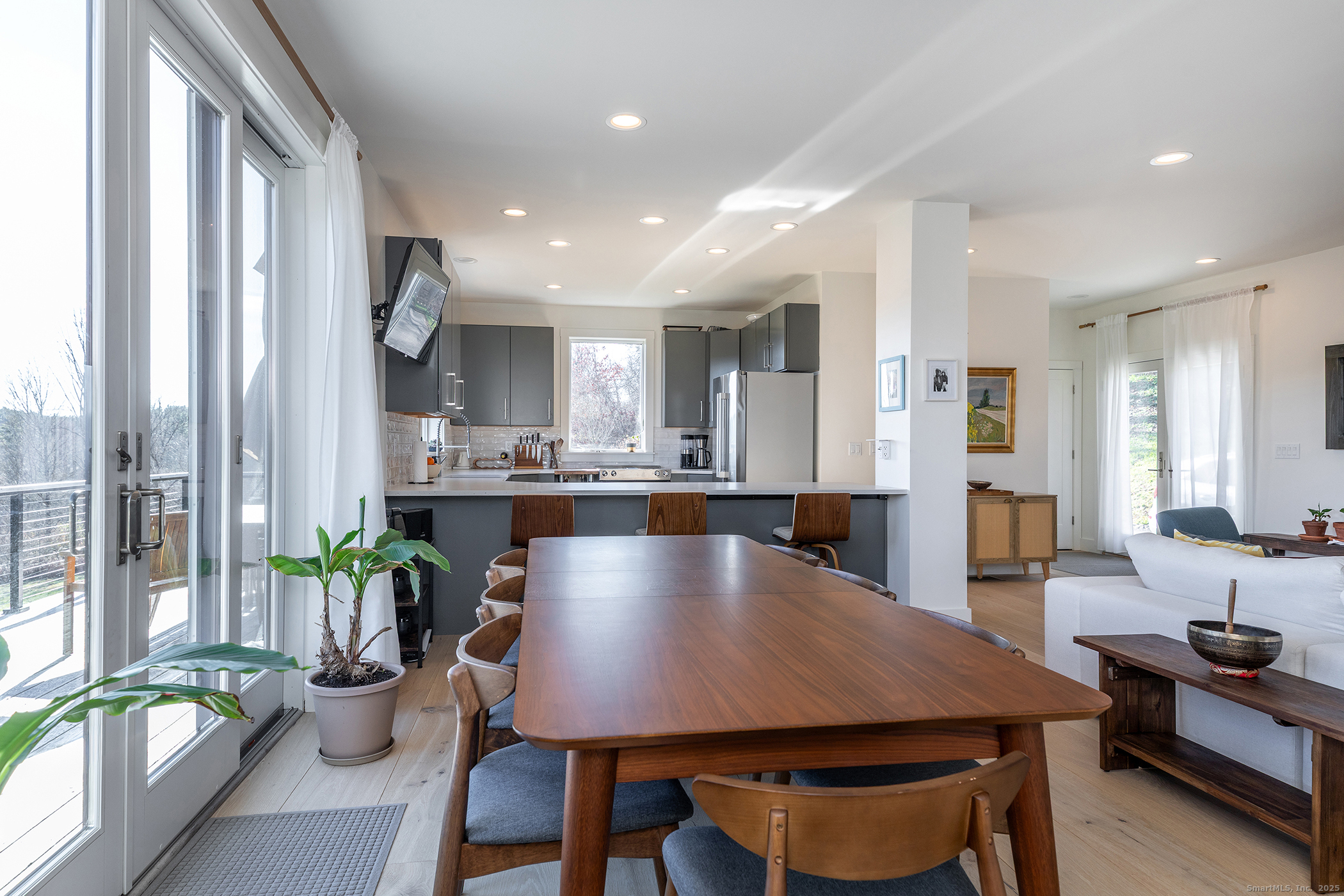 202 Sharon Valley Road Sharon, CT 06069 - Photo 11 of 19 a view of a dining room with furniture and a potted plant