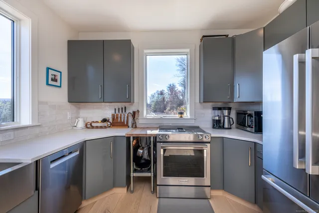 a kitchen with stainless steel appliances granite countertop a stove a sink dishwasher and a refrigerator