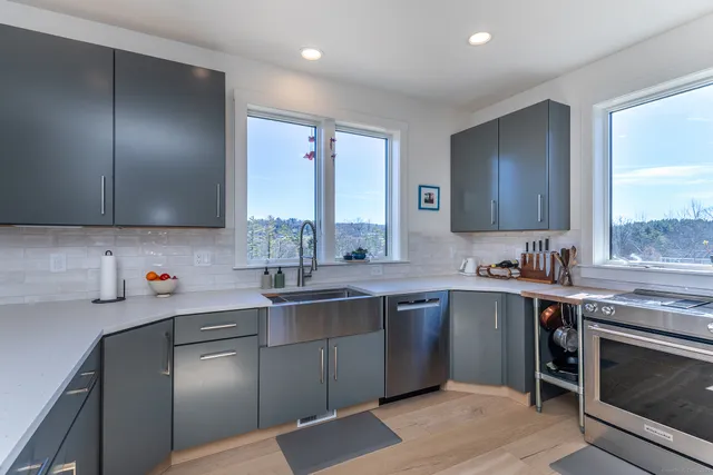a kitchen with a sink stove and cabinets