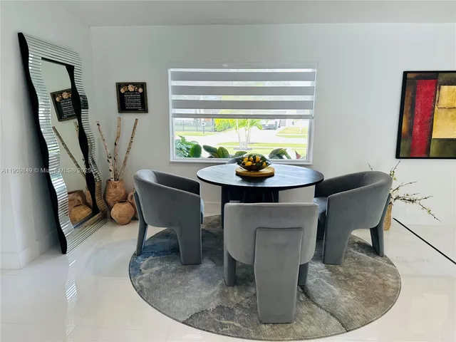 a dining room with furniture and a chandelier