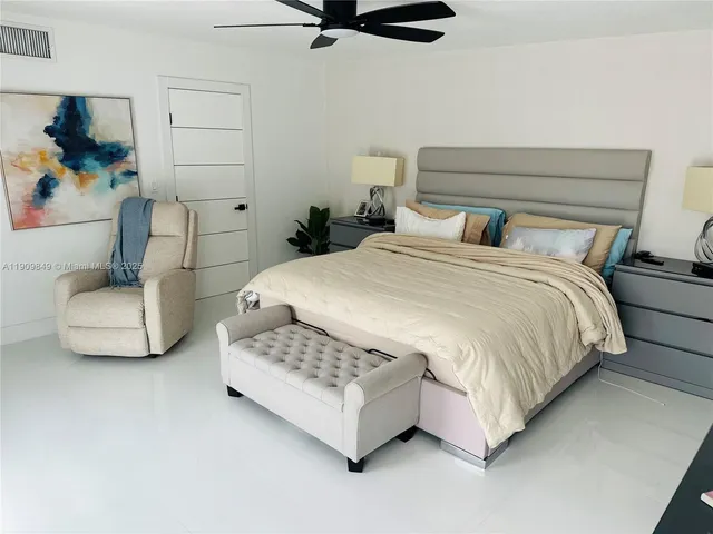 a bedroom with a bed and a couch