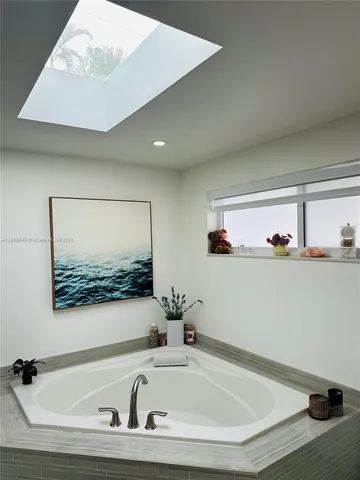 a bathroom with a tub and sink