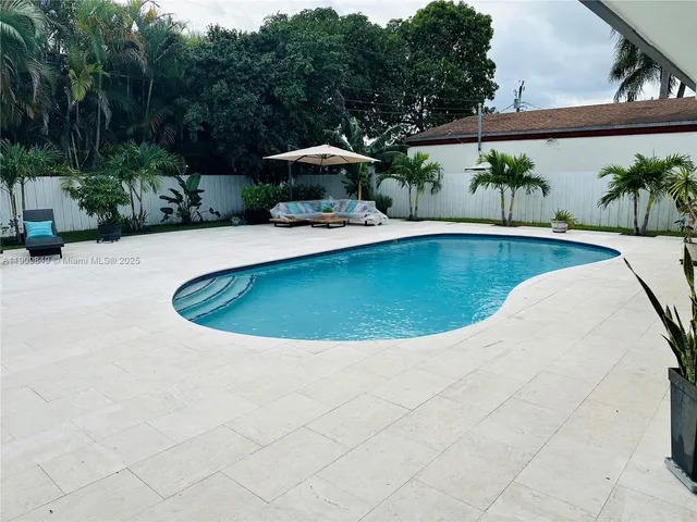 a view of a swimming pool with a patio