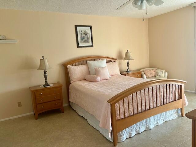 Undisclosed Address Boca Raton, FL 33487 - Photo 15 of 45 a bedroom with a bed and a chandelier