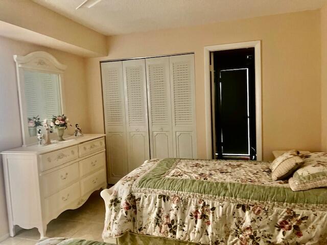 Undisclosed Address Boca Raton, FL 33487 - Photo 22 of 45 a bedroom with a bed and a dresser