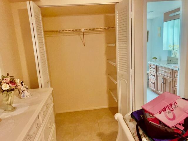 Undisclosed Address Boca Raton, FL 33487 - Photo 24 of 45 a bathroom with a tub sink and mirror