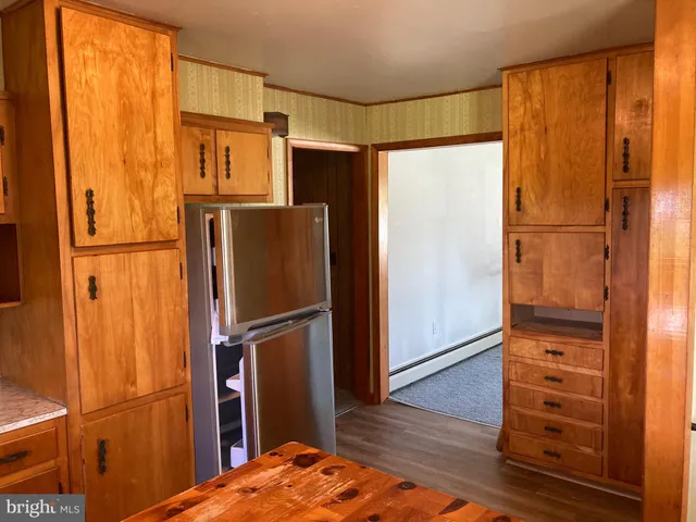 a kitchen with stainless steel appliances granite countertop a sink a stove a counter space and cabinets