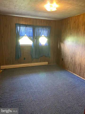 a bedroom with a bed and a curtain