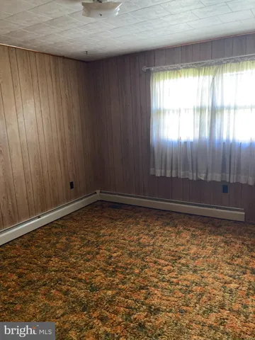 a white toilet sitting next to a window