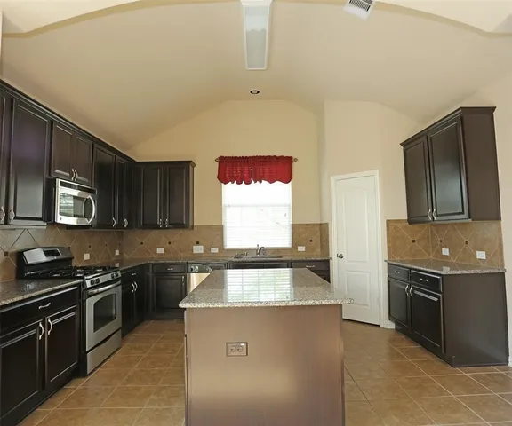 an empty room with a empty space and windows