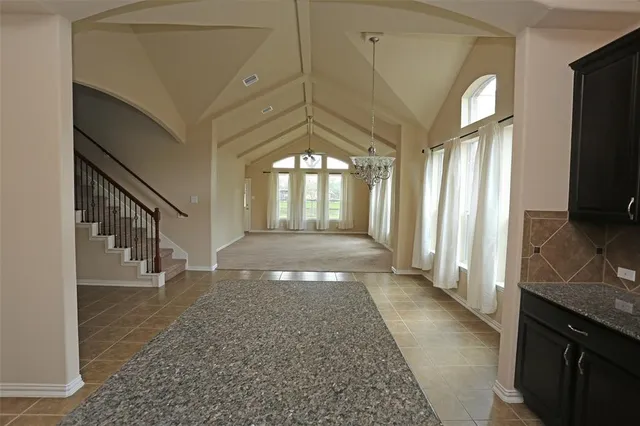 a kitchen with stainless steel appliances granite countertop a stove top oven a sink dishwasher a refrigerator and a microwave