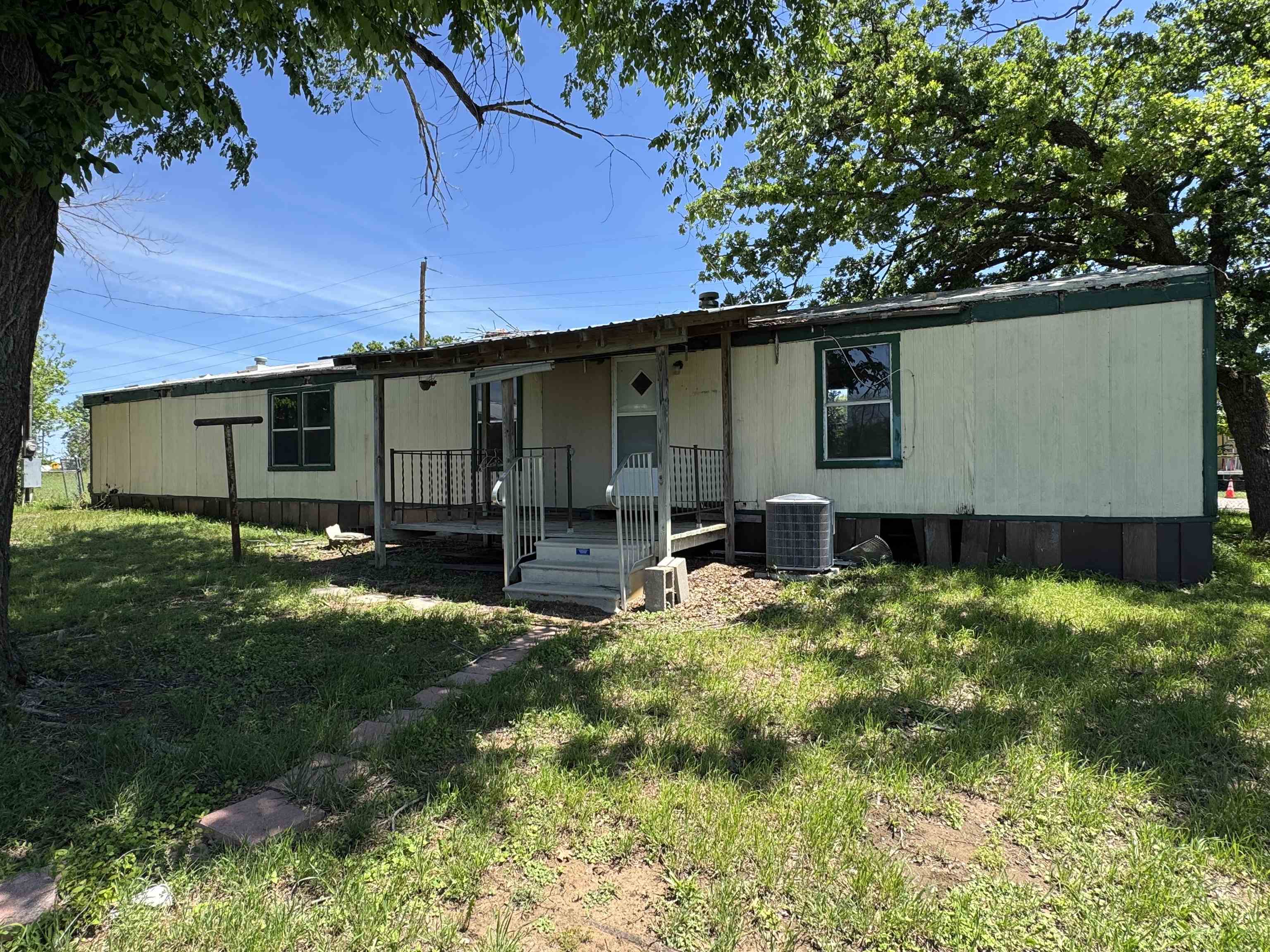 635 Village Loop Tow, TX 78672 - Photo 23 of 27 a backyard of a house with plants and large tree