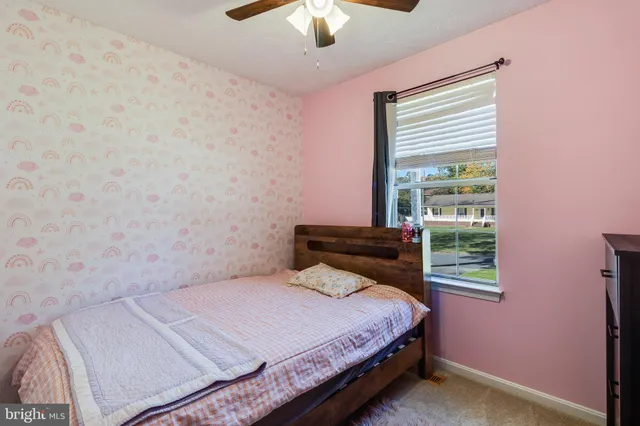 a bathroom with a granite countertop toilet sink and mirror