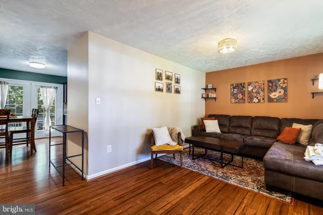 a room with wooden floor and a flat screen tv