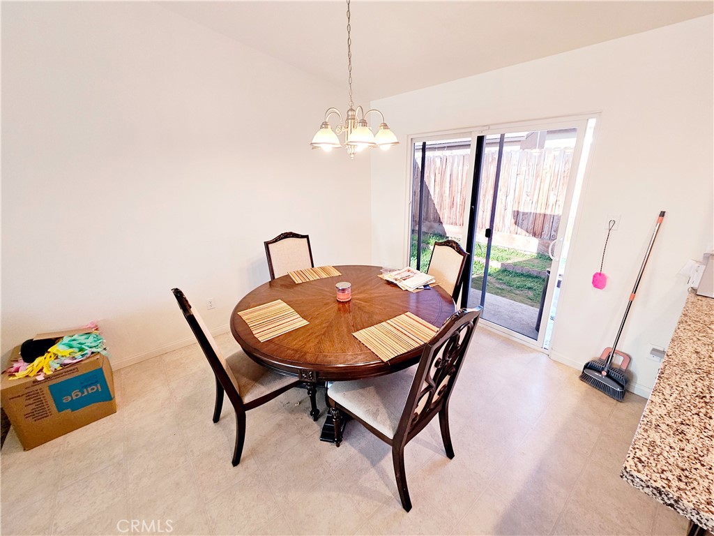 301 Moonstone Beach Court Delano, CA 93215 - Photo 12 of 31 a view of a dining room with furniture and a chandelier